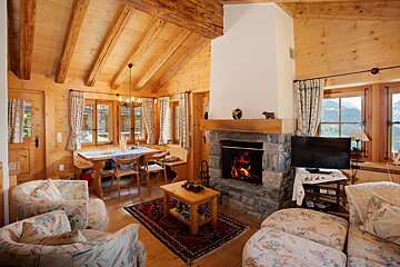 A living room with a fireplace and a television