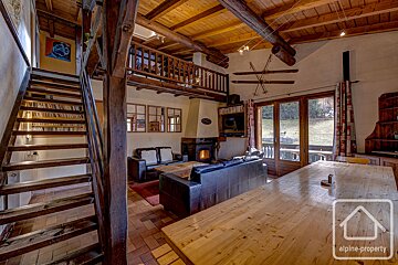 A living room with a staircase leading up to the second floor