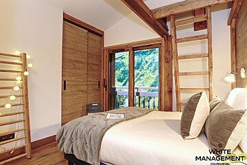 A bedroom with a bed and a sign that says rental designer