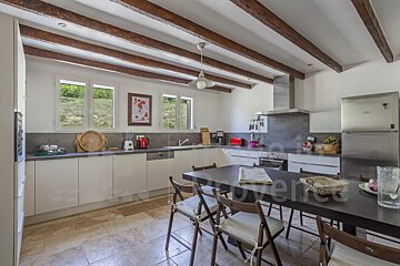 A kitchen with a table and chairs and the word provence in the corner