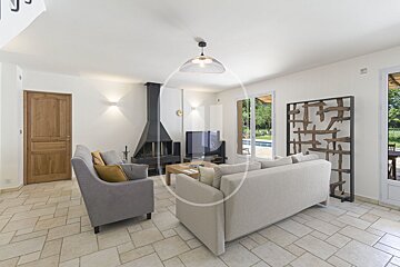 A living room with a couch and chairs and a fireplace