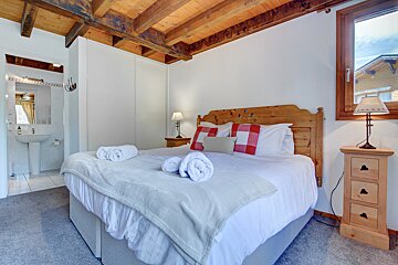A bedroom with a king size bed and a sink