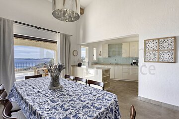 A dining room table with a blue and white table cloth