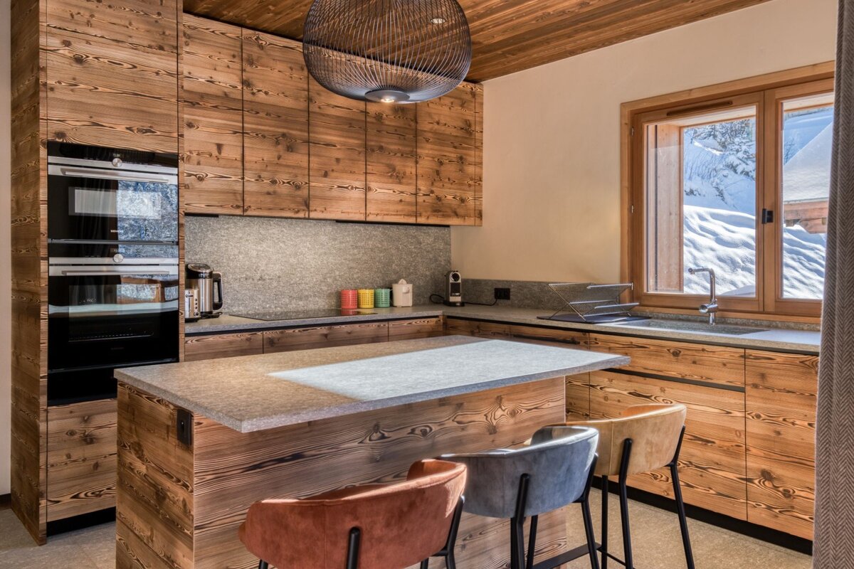 A kitchen with wooden cabinets and a gray counter top