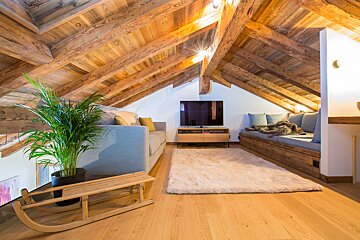 A living room with a couch and a flat screen tv