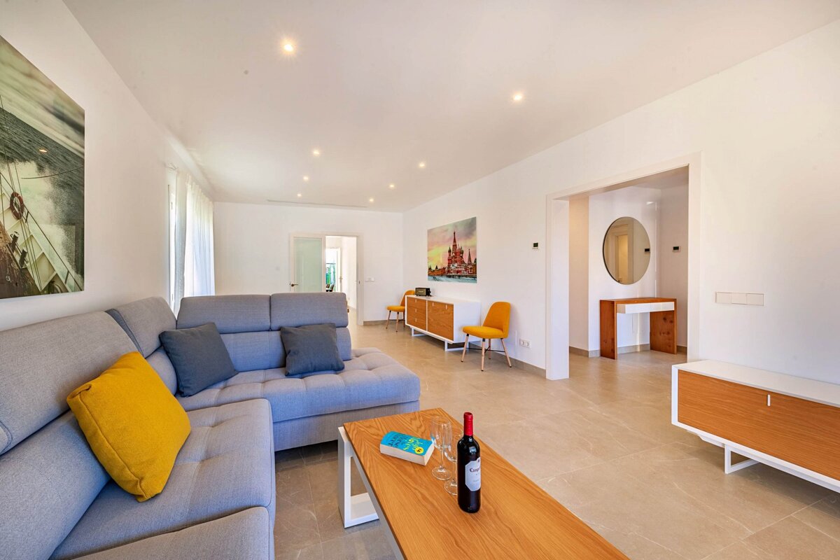 A bottle of wine sits on a coffee table in a living room