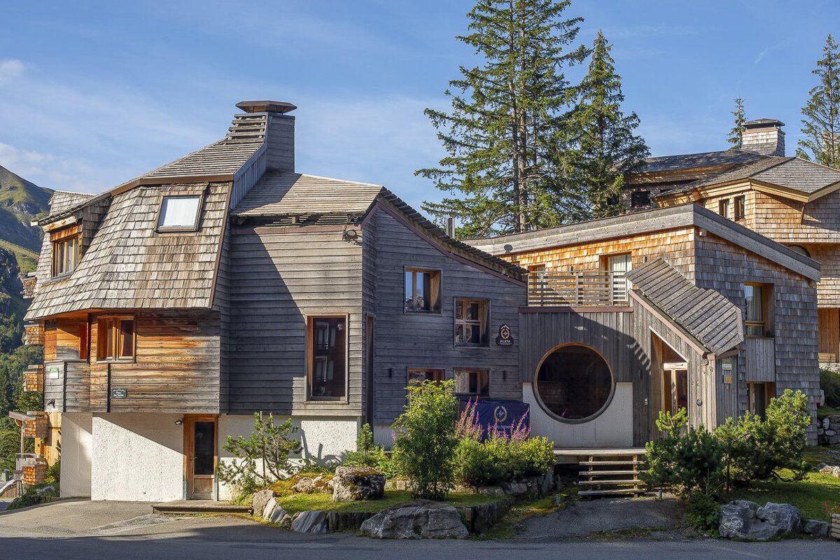 A wooden house with a sign that says ' a ' on it