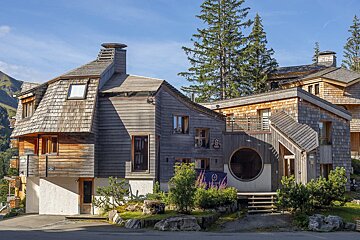 A wooden house with a sign that says ' a ' on it
