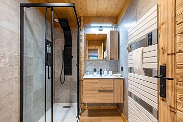 A bathroom with a sink and a walk in shower