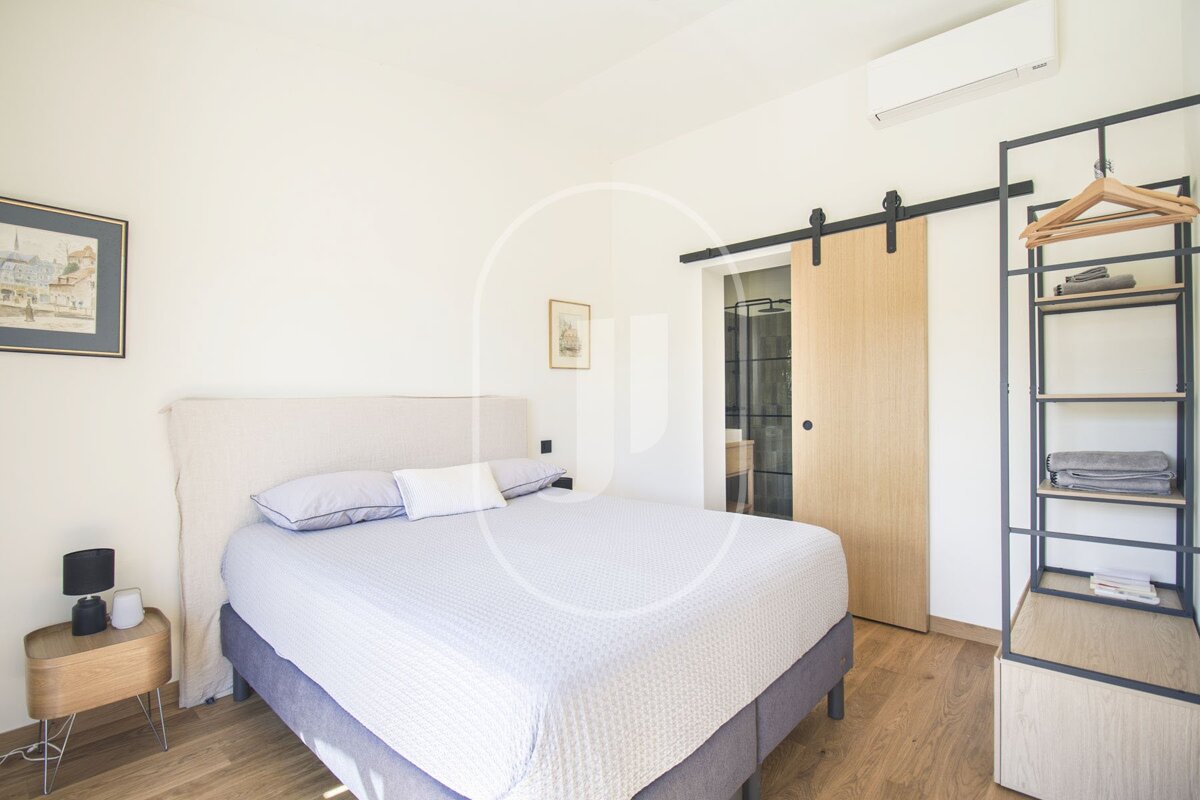 A bedroom with a bed and a sliding barn door