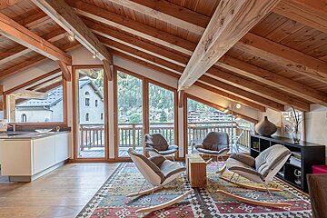 A living room with rocking chairs and a rug