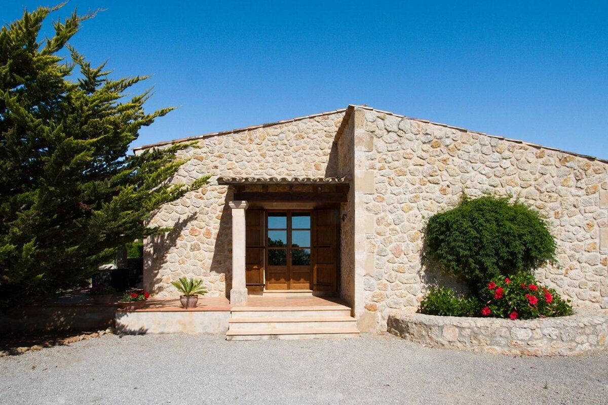 A stone building with a wooden door and steps
