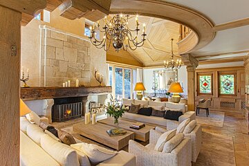 A living room with a fireplace and a chandelier