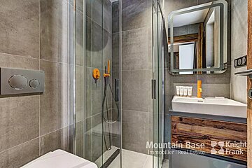 A bathroom with a knight frank logo in the corner