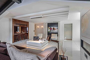A living room with a brown couch and a white coffee table