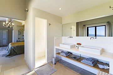 A bathroom with two sinks and the word provence on the wall