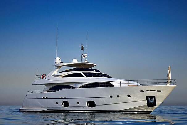 A large white yacht is floating in the ocean