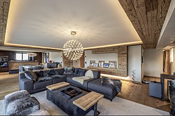 A living room with a couch and a chandelier