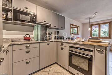 A kitchen with a bosch oven and microwave