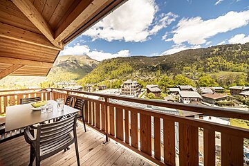 A balcony with a view of a mountain town
