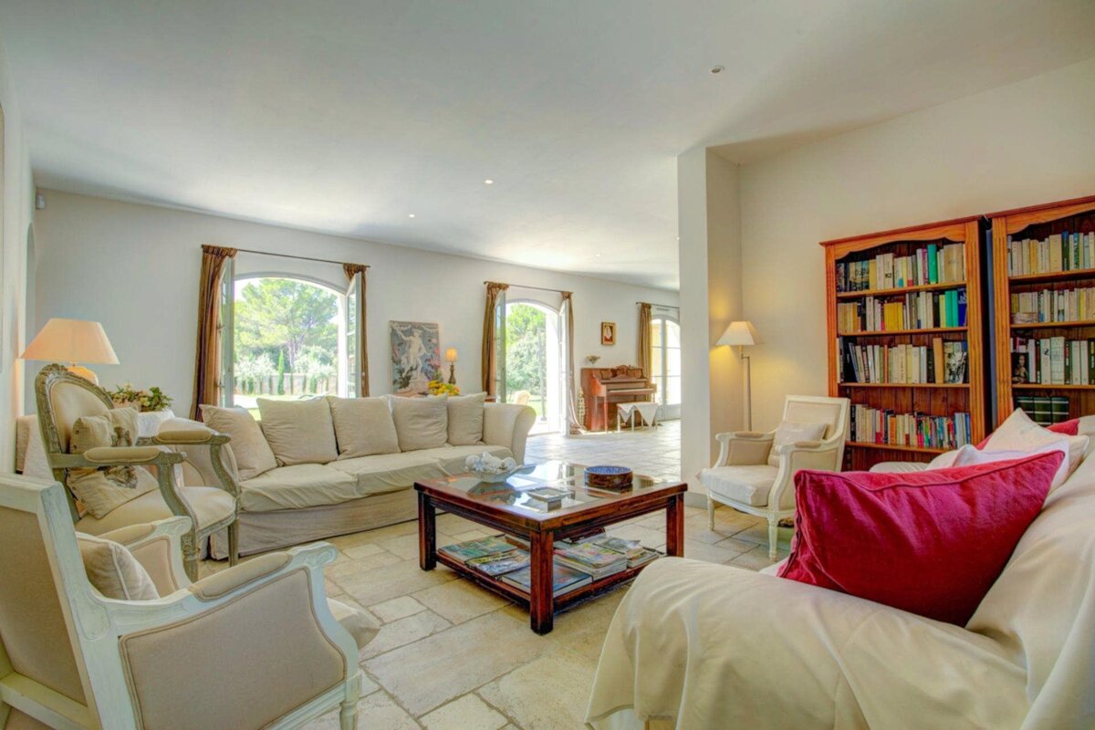 A living room filled with furniture and a piano