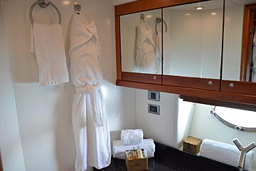 A bathroom with a bathrobe hanging on the wall
