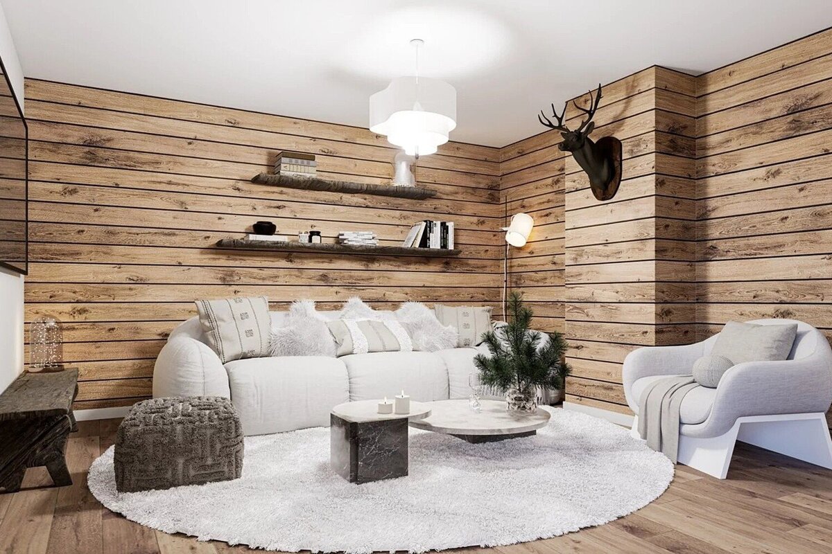 A cozy, modern rustic living room with wood-paneled walls, white sofa and rug, stylish furniture, and a deer head mount.