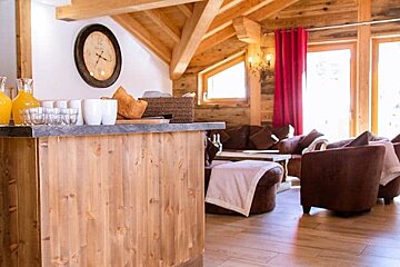 A living room with a clock on the wall and a counter