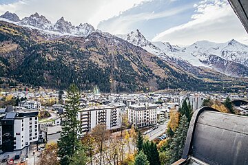 An aerial view of a city with mountains in the background