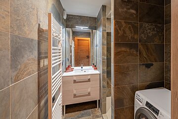 A bathroom with a candy washer and dryer