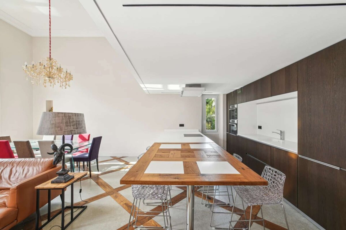 A kitchen with a long wooden table and chairs