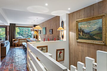A painting of a man playing golf hangs above a staircase