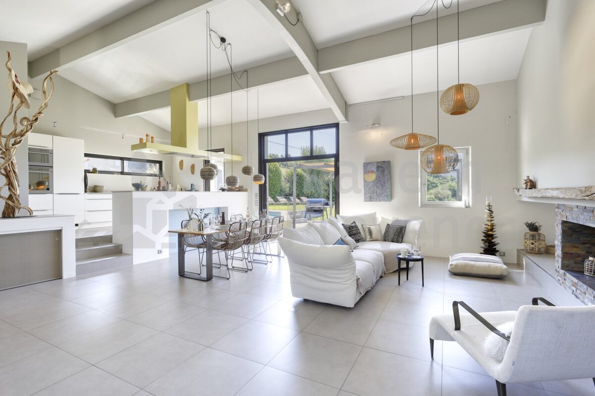 A living room with a white couch and chairs