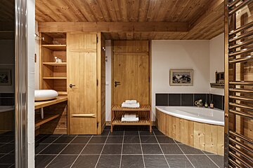 A bathroom with wooden cabinets and a bathtub