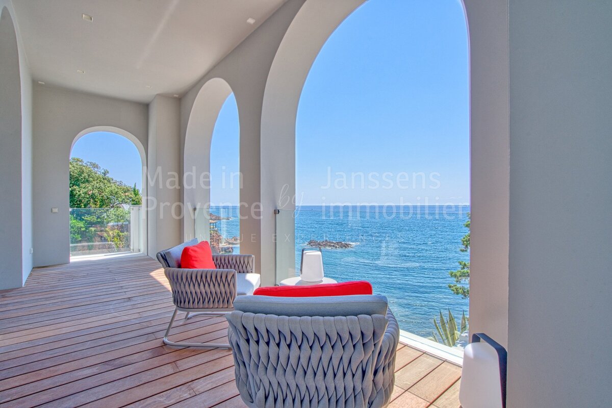 A balcony with a view of the ocean and the words made in provence on the wall