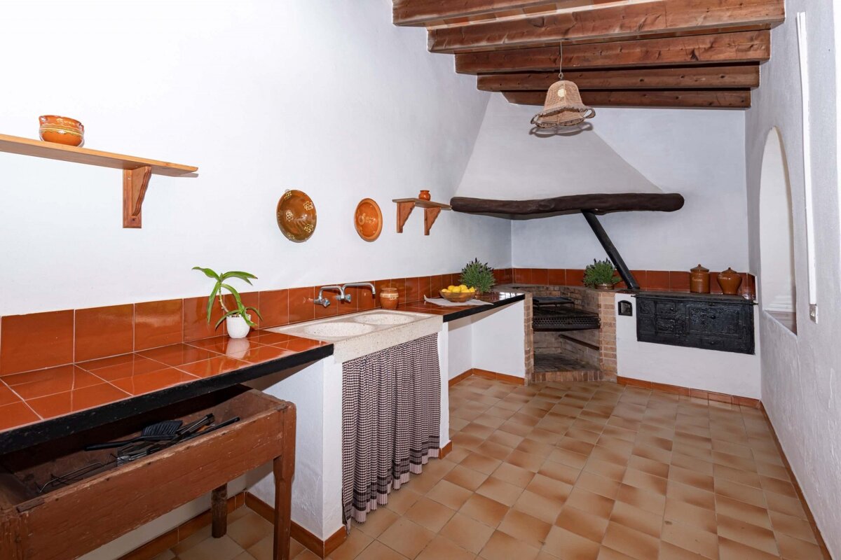 A kitchen with two sinks and a fireplace