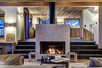 A living room with a fireplace and a table with a book on it