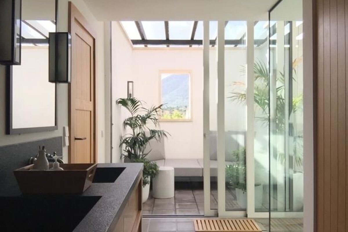 A bathroom with two sinks and a sliding glass door