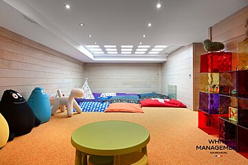 A dining room table with a bottle of wine on it