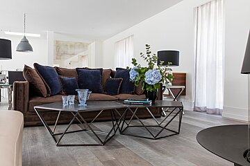 A living room with a couch and two coffee tables