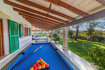 A pool table with balls and cues on it