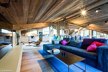 A living room with a blue couch and a black coffee table