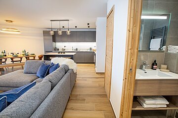 A living room with a gray couch and blue pillows