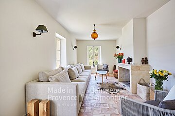 A living room with a couch and a fireplace made in provence
