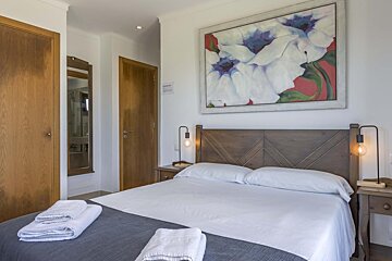 A bathroom with a sink a mirror and a trash can