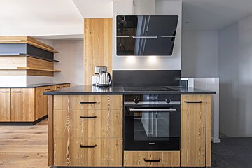 A kitchen with wooden cabinets and a siemens oven