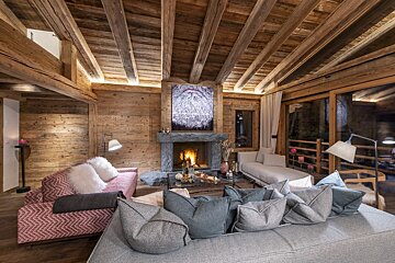 A living room with a fireplace and a painting of santa claus on the wall