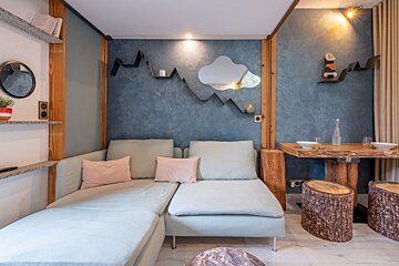 A living room with a couch and a mirror on the wall