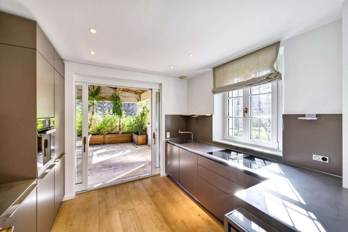 A kitchen with a sliding glass door that leads to a patio