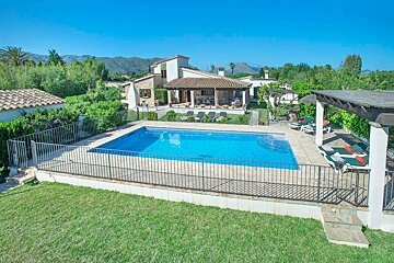 A large swimming pool in front of a house